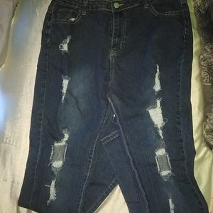 A pair of dark blue jeans with rips down the front of the legs Size 16 women's